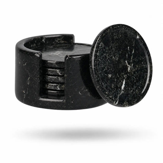A black marble ring with a circular top and a side slot showing stacked interior rings, photographed on a clean white background.
