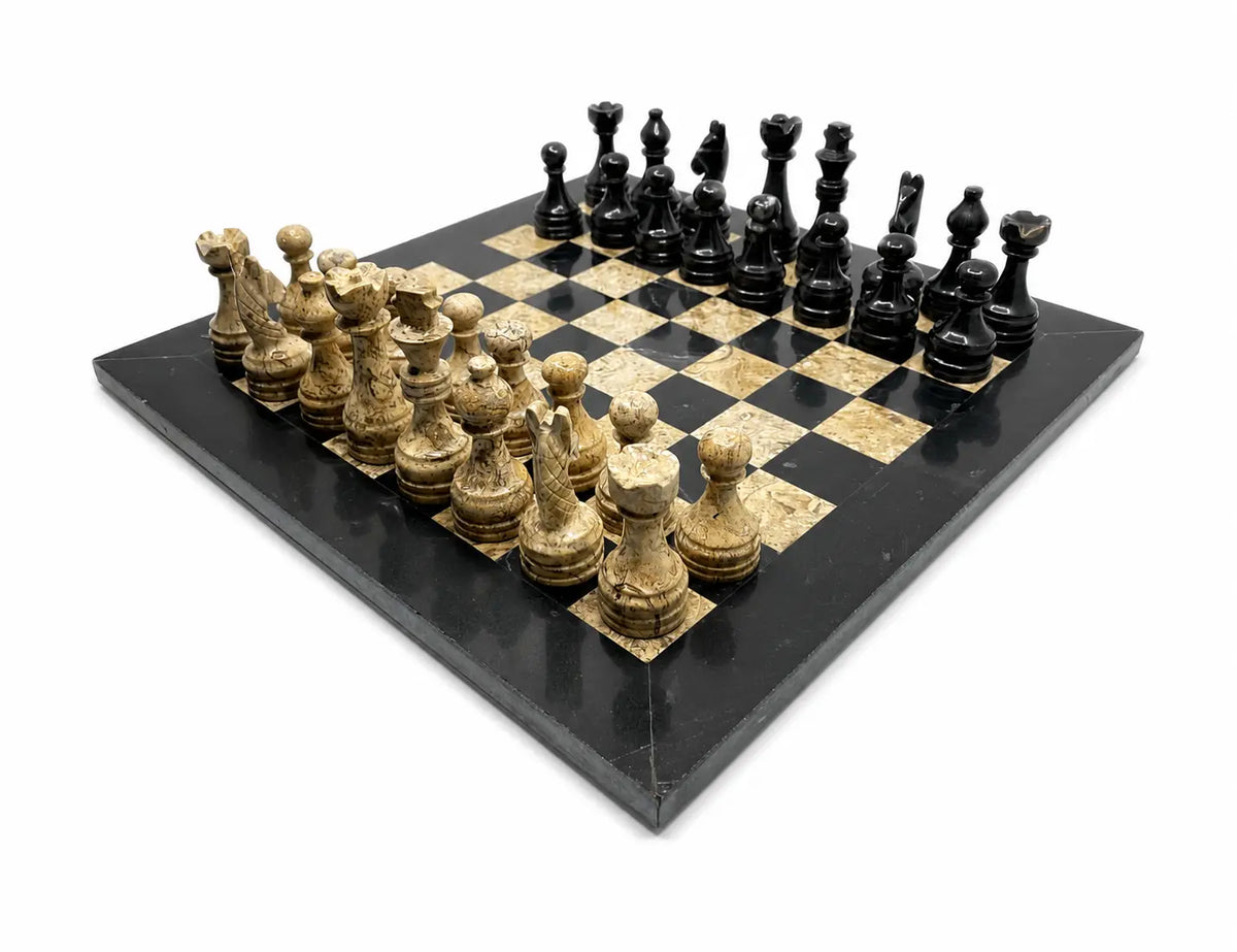 A black and gold marble chessboard with black and gold chess pieces, photographed from an elevated angle on a white background.