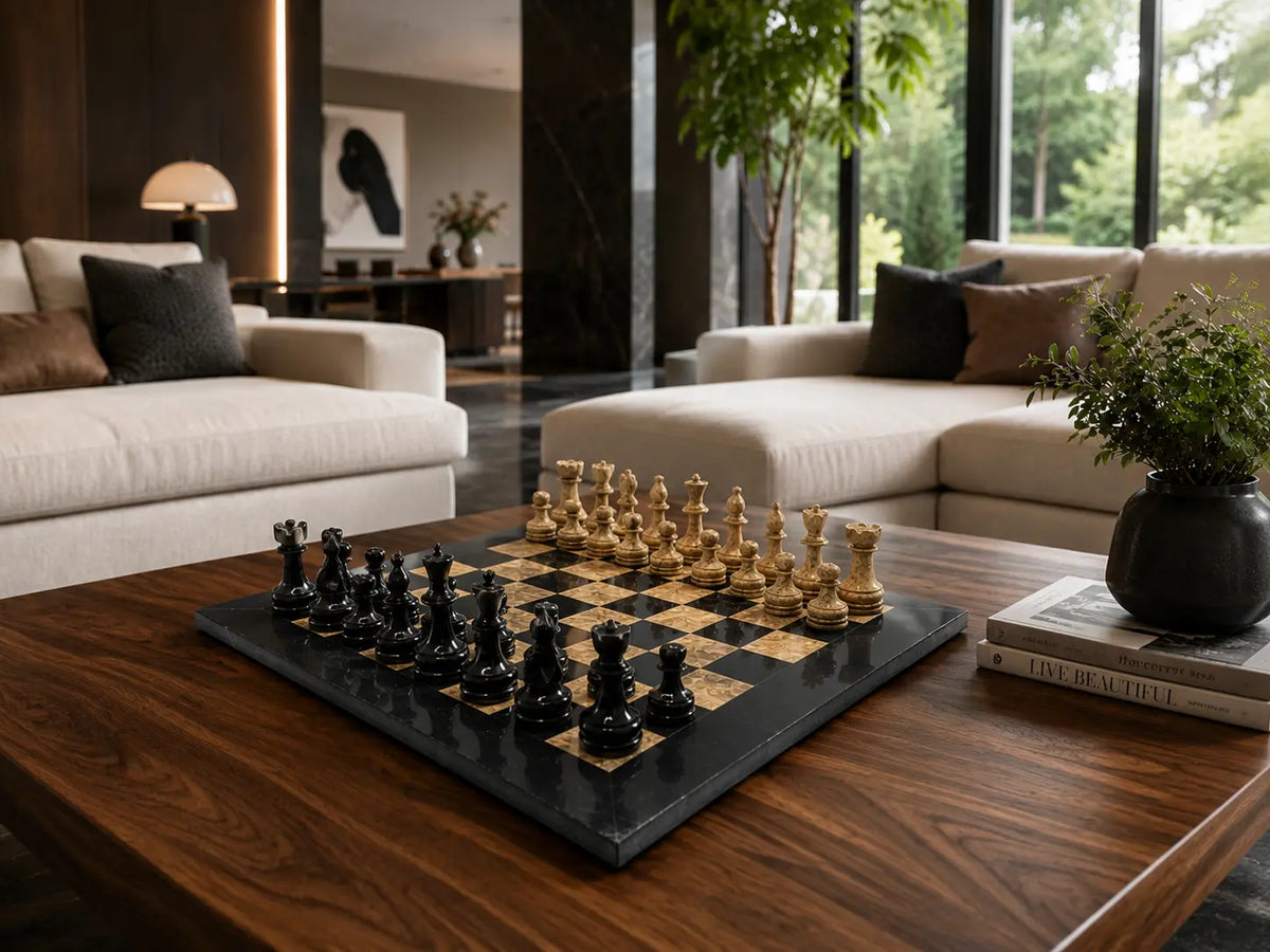 A black and wood chessboard with black and cream chess pieces on a dark wooden coffee table in a modern living room setting.