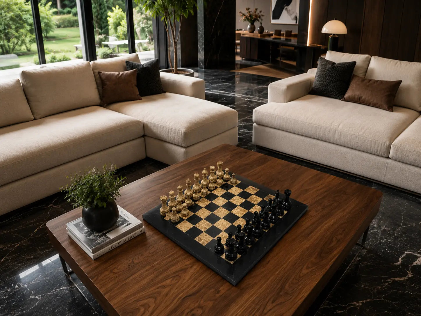 A modern living room scene with two cream sectional sofas, a dark wood coffee table holding a chessboard with gold and black chess pieces, black marble flooring, and large windows in the background.