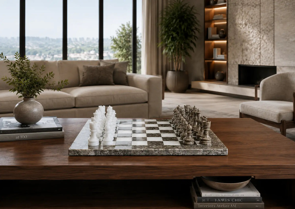 A marble chessboard with white and dark chess pieces sits on a wooden coffee table in a modern living room setting.
