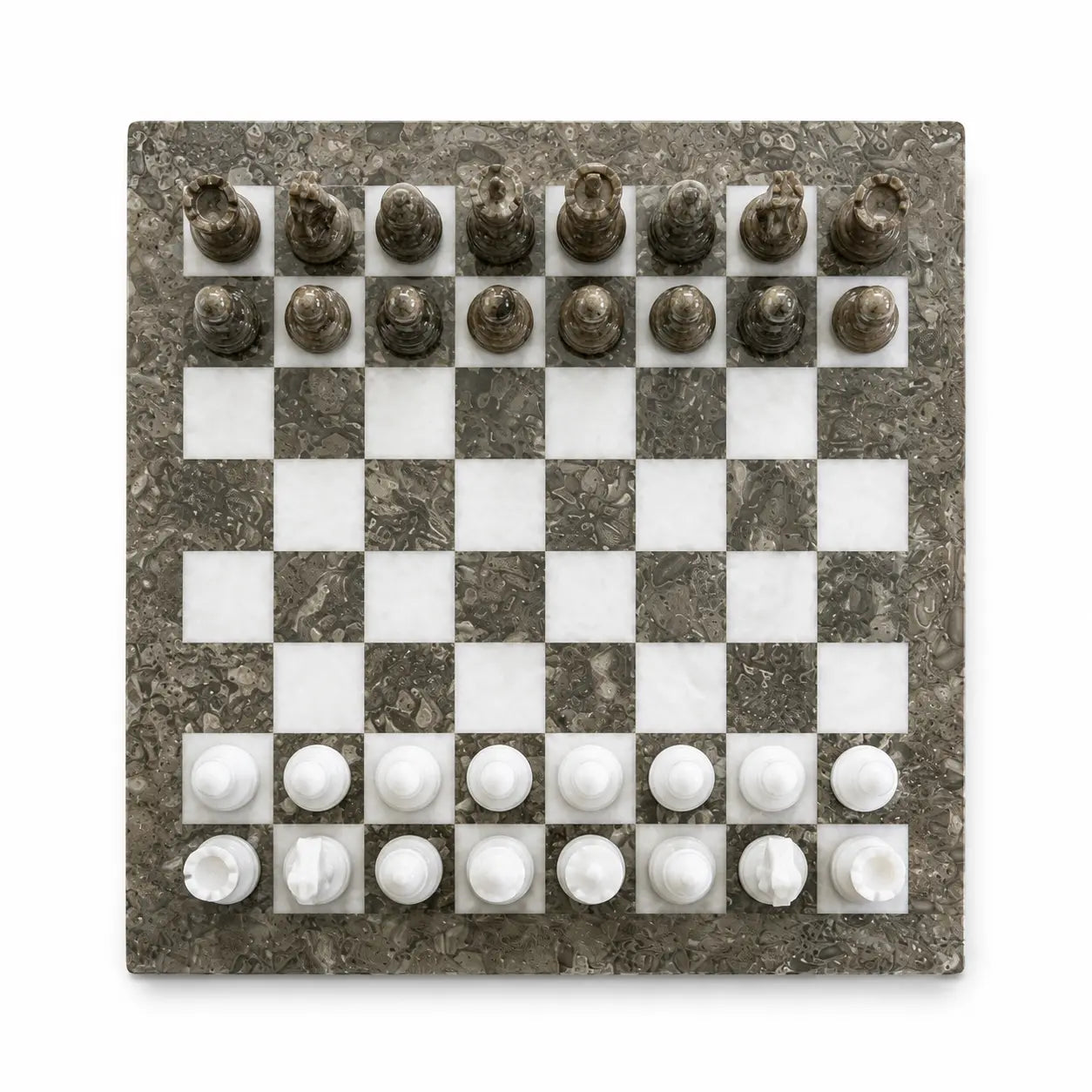 A square marble chessboard with a dark gray and white checkered pattern, featuring white and dark gray chess pieces arranged in their starting positions, shown from a top-down view on a white background.