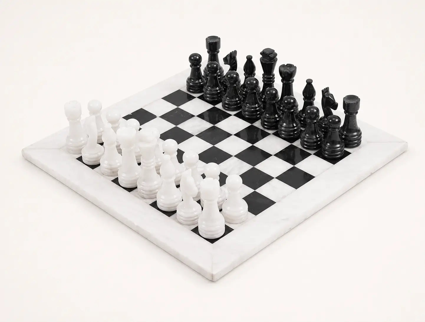 A black and white checkers game set on a white marble board, photographed from an elevated angle against a clean white background.