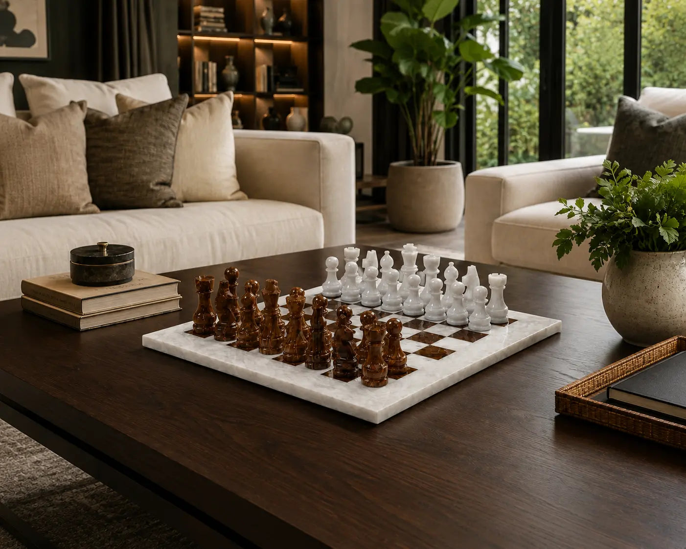 A marble chessboard with carved wooden chess pieces in a modern living room setting on a dark wood coffee table.