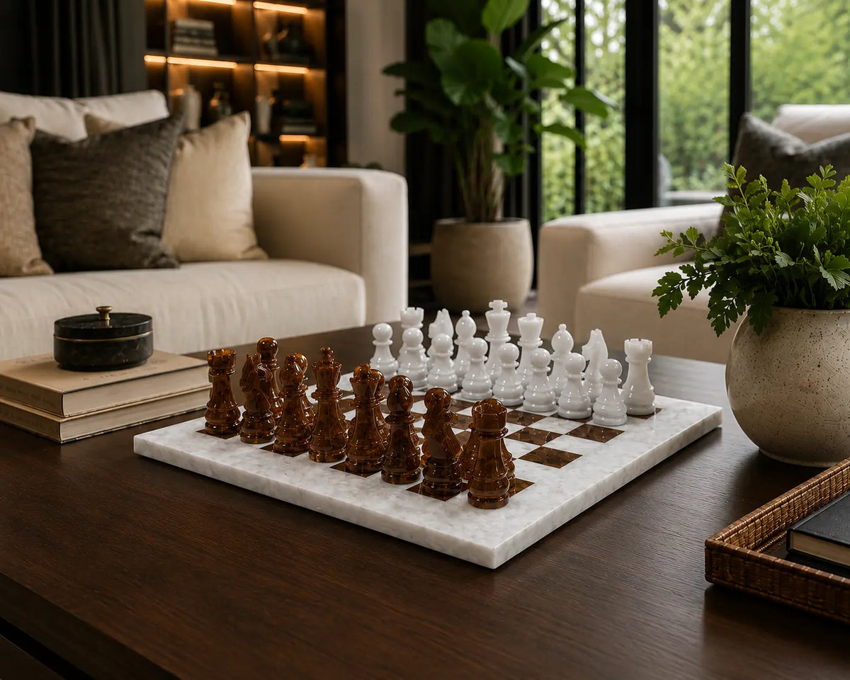 A marble chess set with dark brown wooden pieces and white stone pawns arranged on a dark wood coffee table in a modern living room setting.
